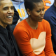 Then-President Barack Obama and first lady Michelle Obama watch a basketball game in Towson, Md., on Nov. 26, 2011.